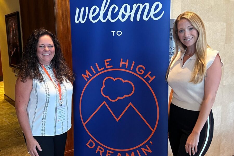 Stephanie & Sarah at Mile High Dreamin' welcome sign