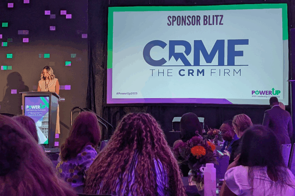 Sarah Burt at the Podium with the CRMF logo on screen