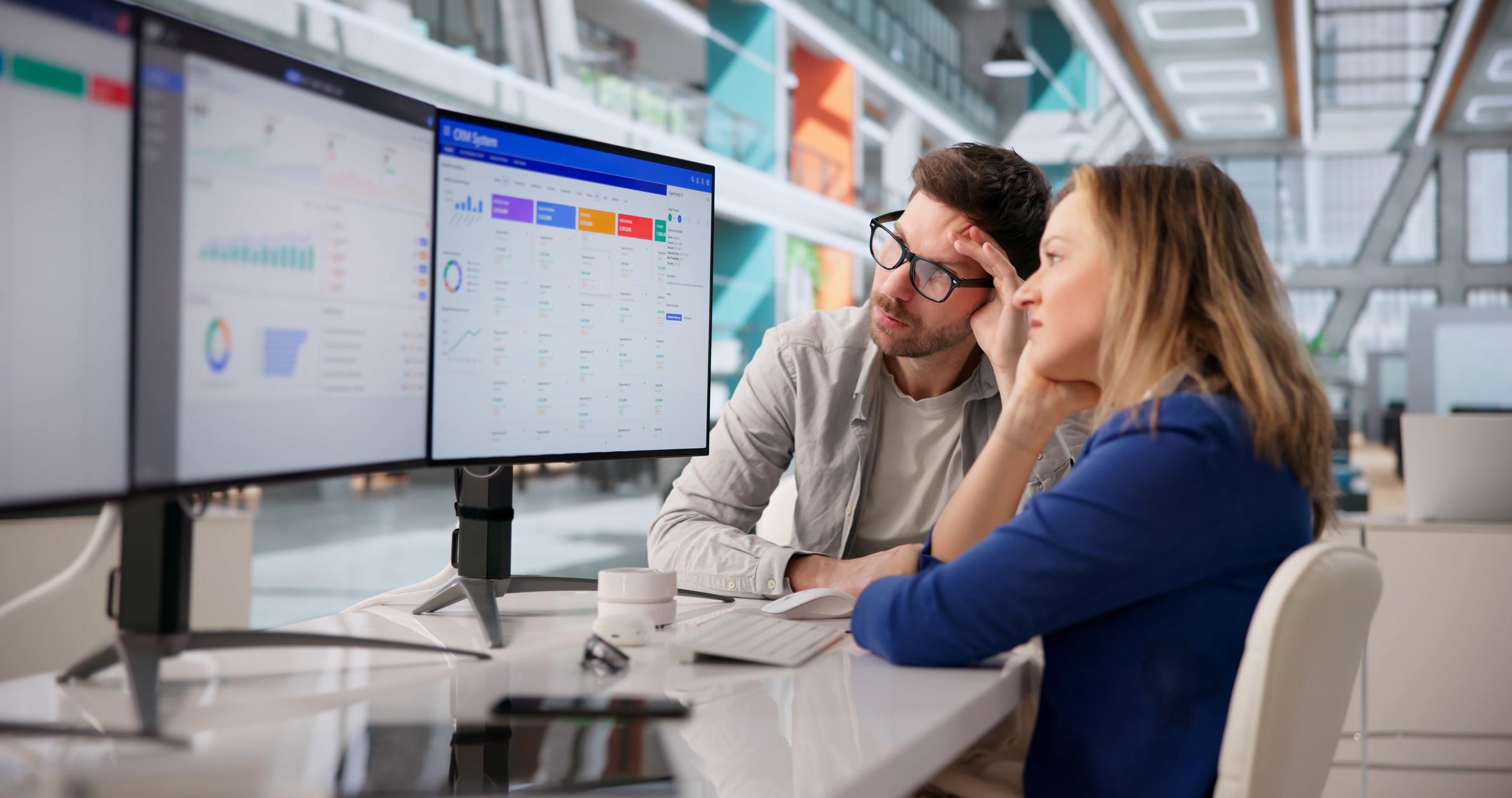 Two people staring at their CRM system